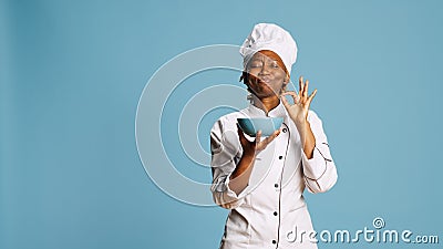 Cheerful gourmet chef smelling food aroma from bowl Stock Photo