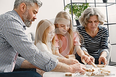 Grandparents play tower game with two girls Stock Photo