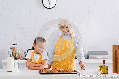 Cheerful granny and child looking at Stock Photo