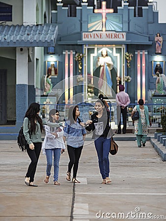 Cheerful group of young women walking the grounds of the Cathedral of Mary Help of Christians Editorial Stock Photo