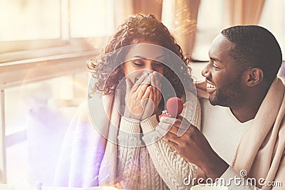 Cheerful handsome man proposing to his girlfriend Stock Photo