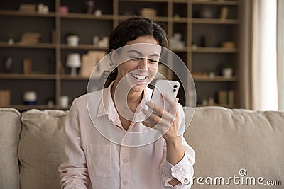 Cheerful happy young smartphone user woman reading text message Stock Photo