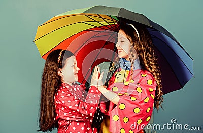 Cheerful hipster children, sisterhood. rain protection. Rainbow. family bonds. Little girls in raincoat. happy little Stock Photo