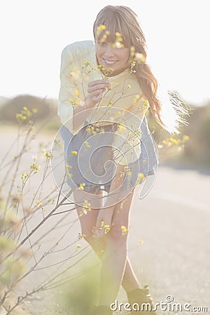 Cheerful hipster girl smelling flowers Stock Photo