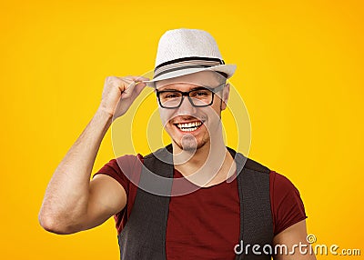 Cheerful hipster in hat smiling at camera Stock Photo