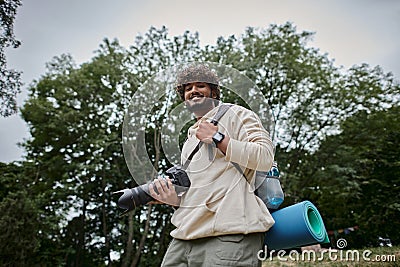 cheerful indian man holding digital camera Stock Photo