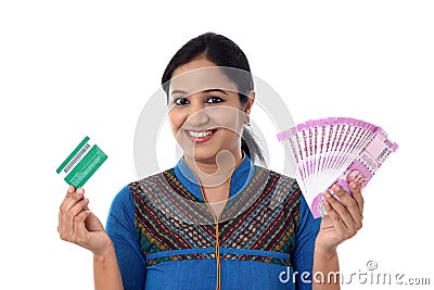 Cheerful Indian woman holding Indian rupee and crredi card Stock Photo