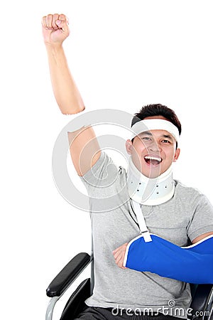 Cheerful injured young man raise his hand Stock Photo
