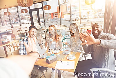 Cheerful international friends sitting in the cafe Stock Photo