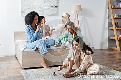 cheerful interracial women doing beauty procedures Stock Photo