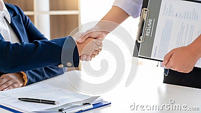 Cheerful interviewer hr manager welcoming women applicant at job interview handshaking at group meeting talk and effective negotia Stock Photo