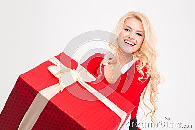 Cheerful joyful female smiling and holding big red present box Stock Photo
