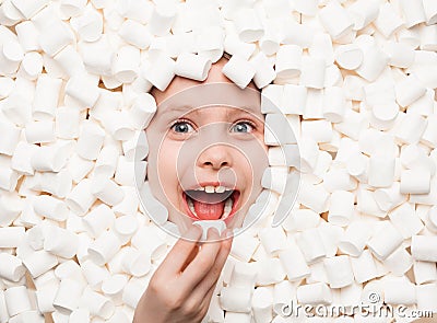 Cheerful kid posing in white marshmallows Stock Photo