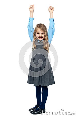 Cheerful kid raising her hands in excitement Stock Photo