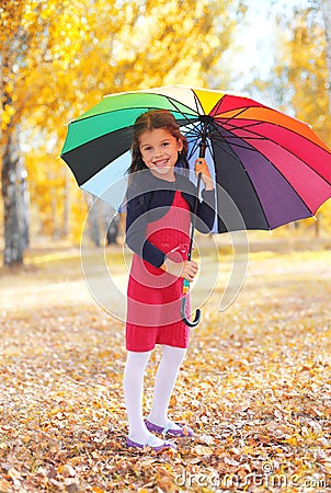 Cheerful little girl child with colorful umbrella in autumn Stock Photo