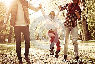 Little girl playing with parents and enjoying together Stock Photo