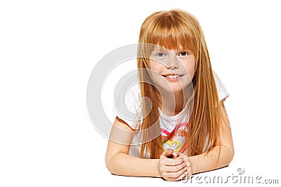 A cheerful little girl with red hair is lying ; isolated on the white Stock Photo