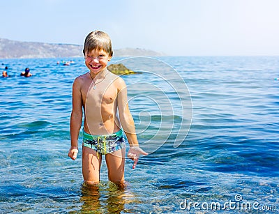 Cheerful llittle boy playing outdoors at the sea Stock Photo