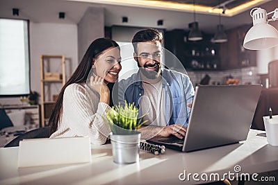 Young couple using laptop and analyzing their finances Stock Photo