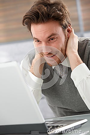 Cheerful man browsing internet smiling Stock Photo