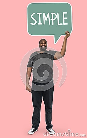 Cheerful man showing word simple in a speech bubble Stock Photo