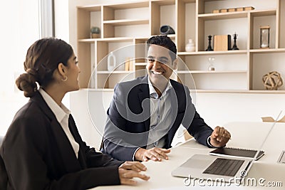 Cheerful manager and client discussing successful cooperation at laptop Stock Photo