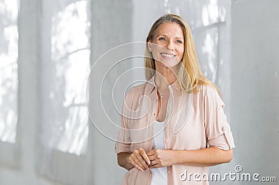 Smiling mature woman standing Stock Photo