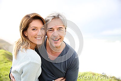 Cheerful middle-aged couple on seaside Stock Photo