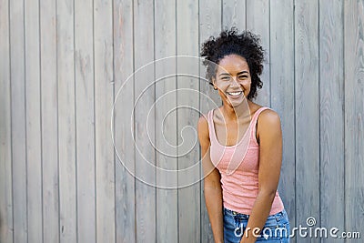 Cheerful mixed race woman standing outdoors Stock Photo