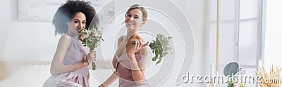 cheerful multicultural women holding wedding bouquets Stock Photo