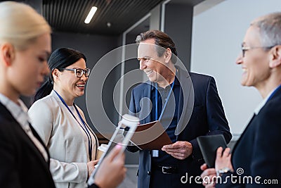 Cheerful multiethnic business people with coffee Stock Photo