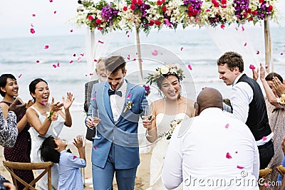 Cheerful newlyweds at beach wedding ceremony Stock Photo