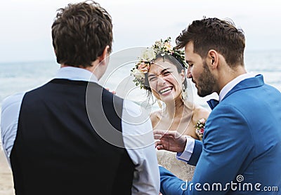 Cheerful newlyweds at beach wedding ceremony Stock Photo