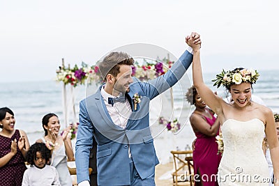 Cheerful newlyweds at beach wedding ceremony Stock Photo