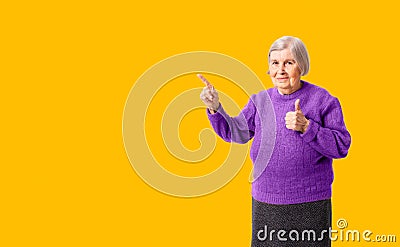 Cheerful octogenarian woman showing on empty place for copy space. Stock Photo