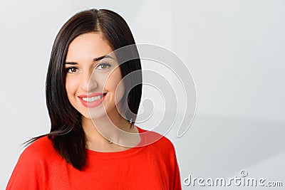 Cheerful optimistic confident brunette girl dressed in red with perfect smile Stock Photo