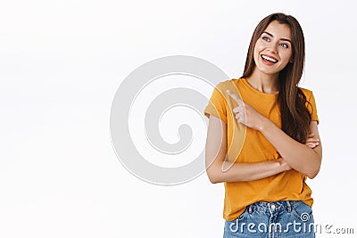 Cheerful outgoing good-looking young woman discuss awesome party or event, pointing looking curious and pleased upper Stock Photo