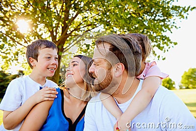 Cheerful parents spending weekend with children Stock Photo