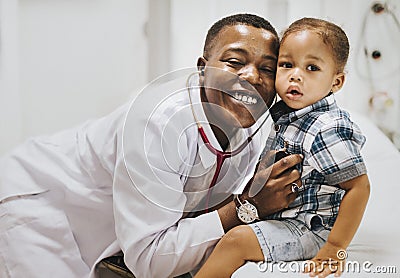 Cheerful pediatrician doing a medical checkup of a young boy Stock Photo