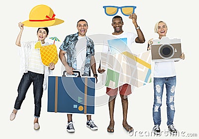 Cheerful people holding travel icons Stock Photo