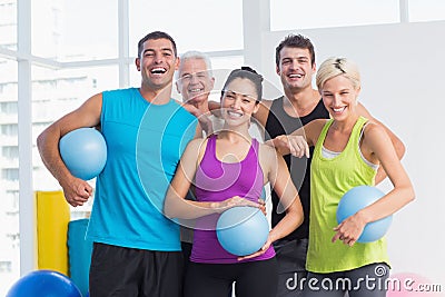 Cheerful people with medicine balls in fitness studio Stock Photo