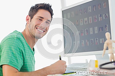Cheerful photo editor working on graphics tablet Stock Photo