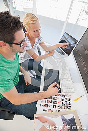 Cheerful photo editors working together on graphics tablet Stock Photo
