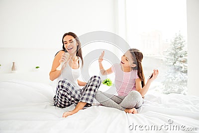 Cheerful positive glad charming beautiful mom having fun with he Stock Photo