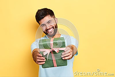 Cheerful positive kind man giving a present to a friend Stock Photo