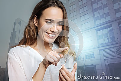 Cheerful positive woman holding an innovative smartphone Stock Photo