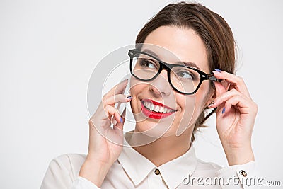 Cheerful pretty business woman in glasses talking on cell phone Stock Photo