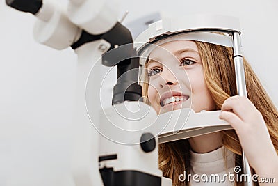 Cheerful pretty child getting her eyesight tested Stock Photo