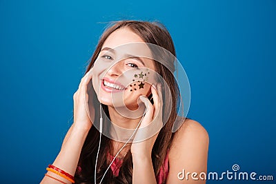 Cheerful pretty young woman listening to music Stock Photo