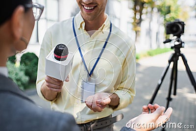 cheerful reporter holding microphone Stock Photo